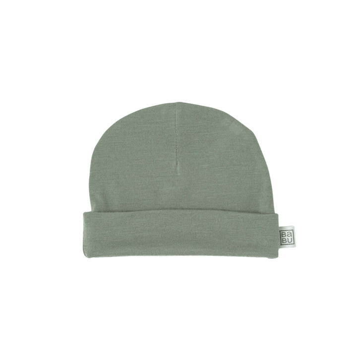 A plain olive-green beanie with a folded brim and a small rectangular tag on the side, this snug fit Babu Merino Baby Hat by Babu is a perfect baby essential.