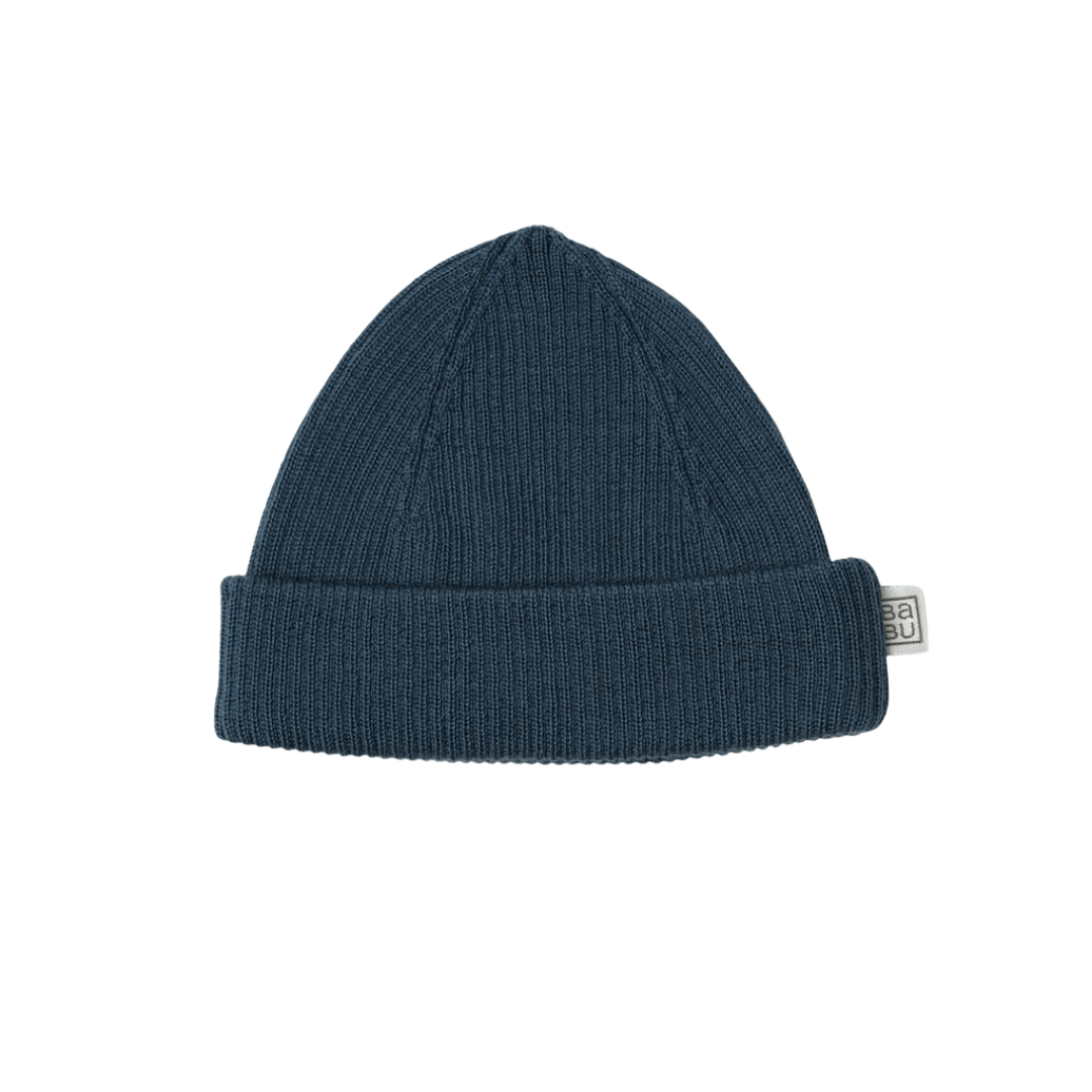 A dark blue Babu Merino Rib Hat by Babu with a folded brim and a white label attached to the side.