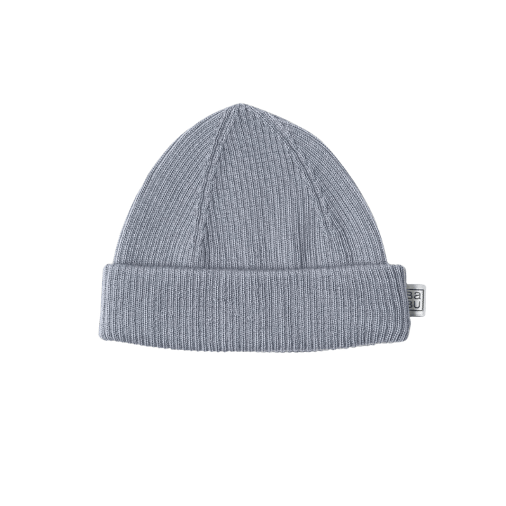 A folded grey Babu Merino Rib Hat with a small tag on the right side.