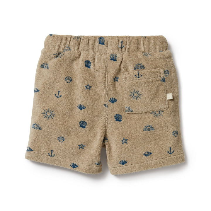 Wilson & Frenchy Organic Terry Shorts, available in size 0-3 months, feature a charming nautical pattern with dark blue anchors, shells, suns, and starfish on a tan background. Made from GOTS-certified organic cotton, these shorts include an elastic waistband and a small back pocket—perfect as a summer staple for your little one.