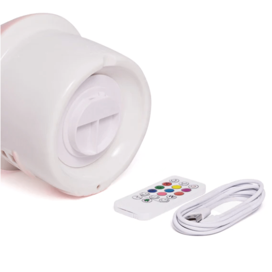 The Little Belle Nightlights Ceramic Nightlight - LUCKY LASTS - FAIRY HOUSE ONLY from Little Belle Nightlights is a whimsical white device featuring a control panel, along with a remote control and USB cable. It effortlessly blends modern functionality with enchanting design, reminiscent of the iconic Little Belle House Nightlight.