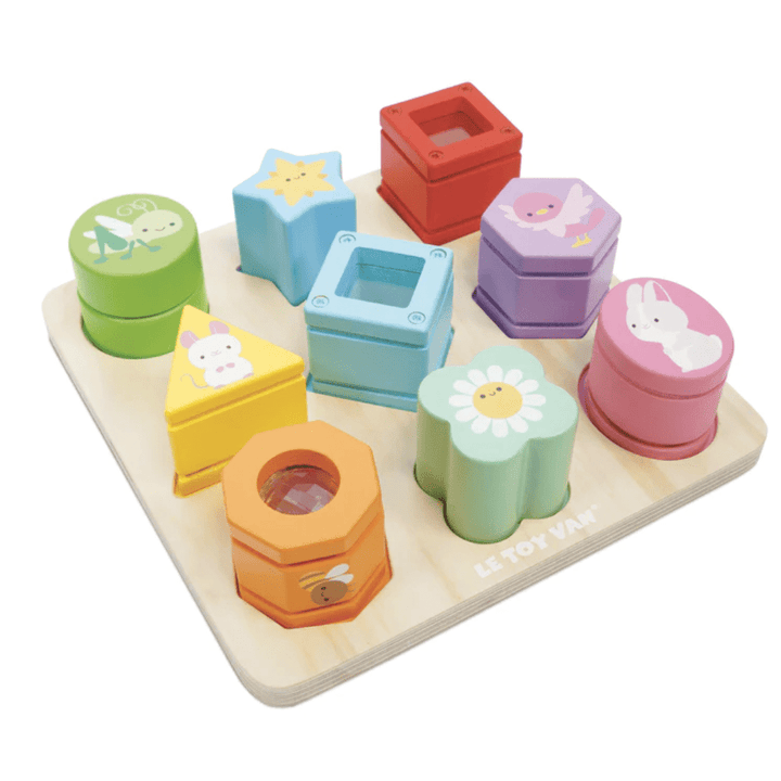 The Le Toy Van Petilou Sensory Shapes - LUCKY LAST is a charming wooden shape sorter featuring vibrant pieces like stars, flowers, and bunnies. Ideal for enhancing fine motor skills, this delightful toy provides a sensory shapes experience as children fit each piece into the board.