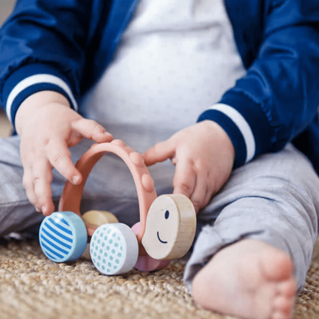 Close-Up-Of-Little-Hands-Playing-With-Hape-Turbo-Turtle-Naked-Baby-Eco-Boutique