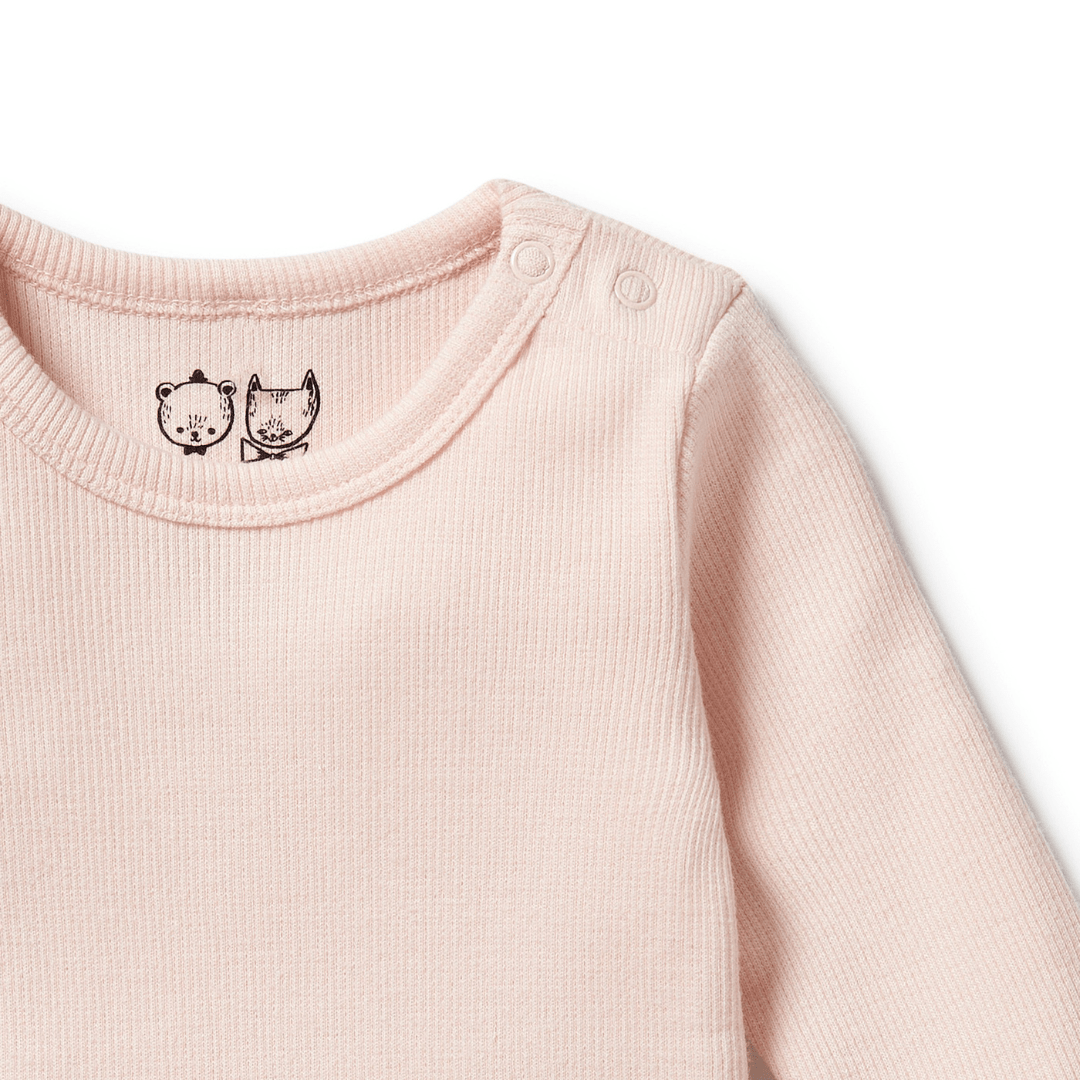 Close-up of a light pink Wilson & Frenchy Organic Rib Long Sleeved Onesie featuring two small animal illustrations on the neckline and snap buttons on the shoulder, adding a charming touch to any baby wardrobe. Made from organic cotton rib for ultimate comfort.