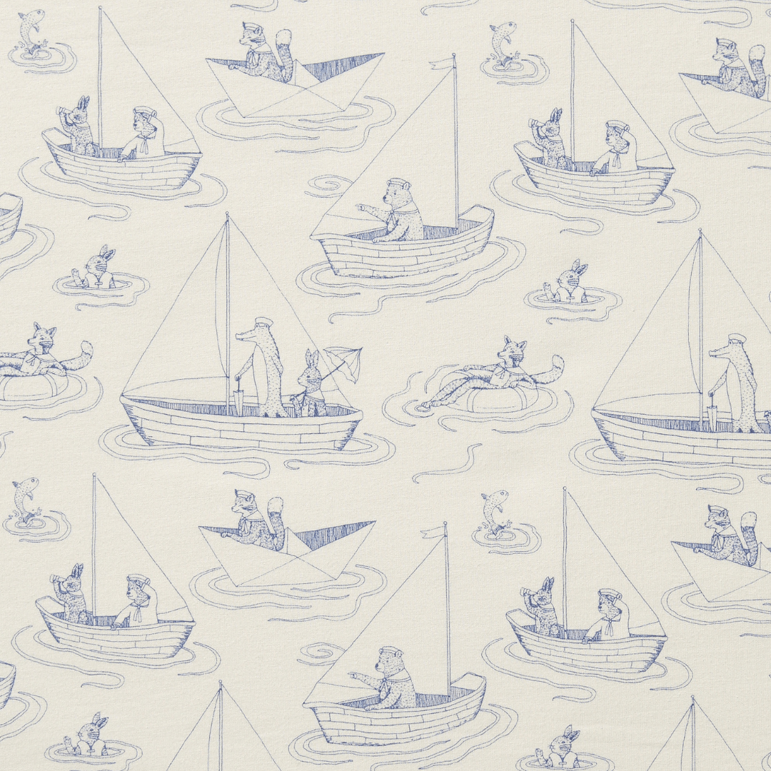 The Wilson & Frenchy Organic Cotton Cot Sheet - LUCKY LAST - TRIBAL WOODS ONLY features various animals engaging in boating activities, including rowing, sailing, and paddling, set against a cream background with blue line drawings—perfect as a GOTS-certified baby shower gift.