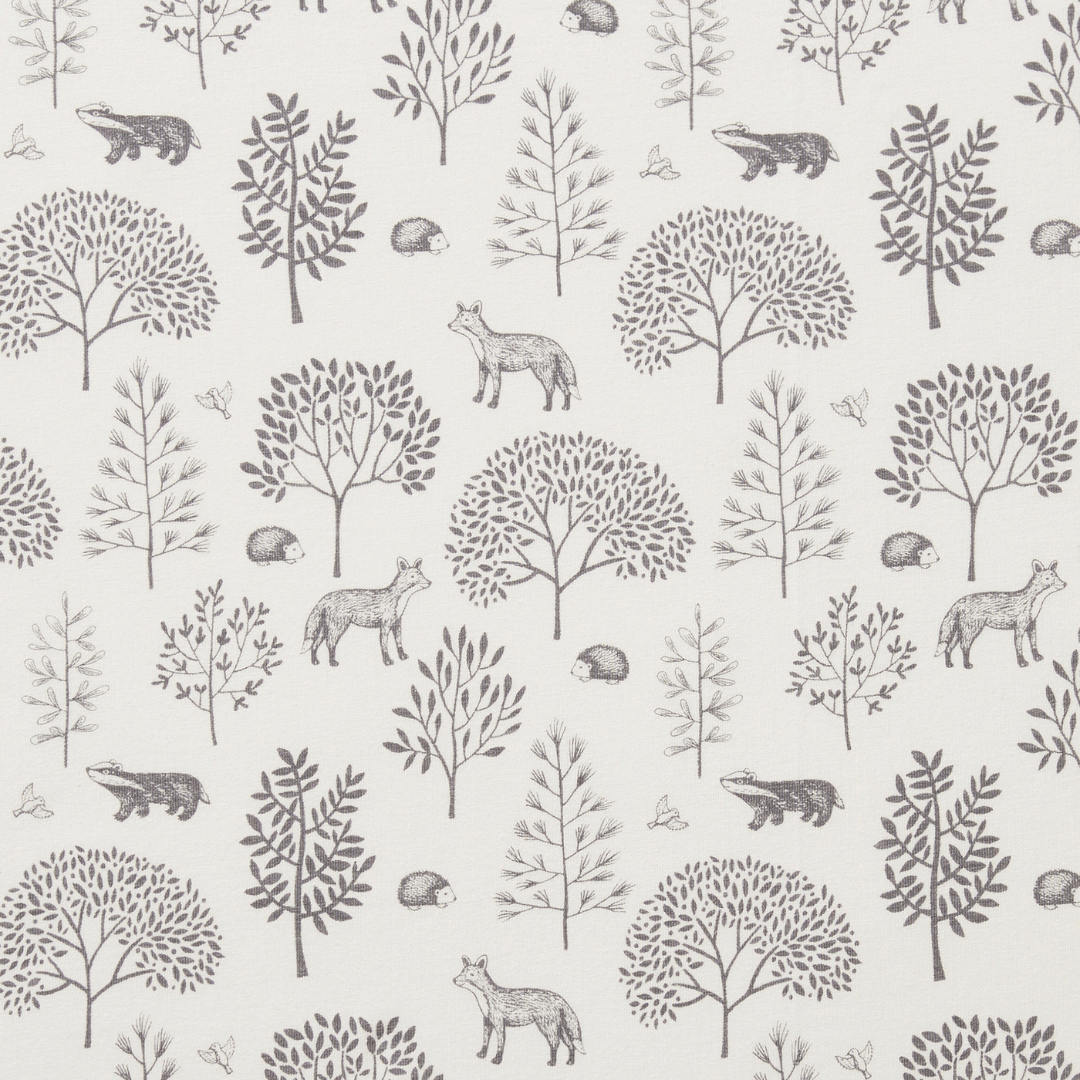 Featuring a monotone pattern with various trees, foxes, hedgehogs, badgers, and butterflies arranged in a repeating design on a light background, the Wilson & Frenchy Organic Cotton Cot Sheet - LUCKY LAST - TRIBAL WOODS ONLY is a charming choice for any nursery. This delightful design makes an ideal baby shower gift.