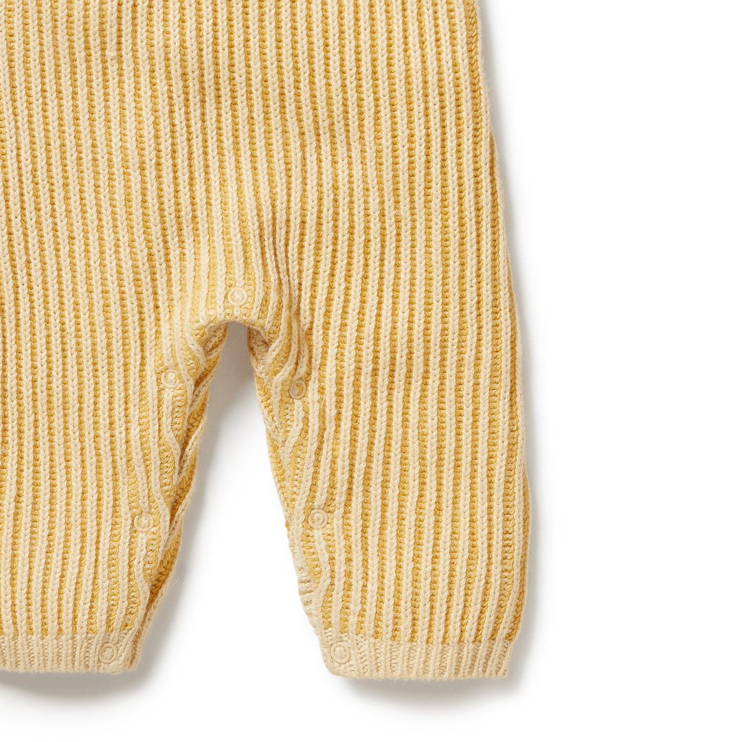 A pair of Dijon yellow Wilson & Frenchy Knitted Ruffle Overalls with button closures at the legs.