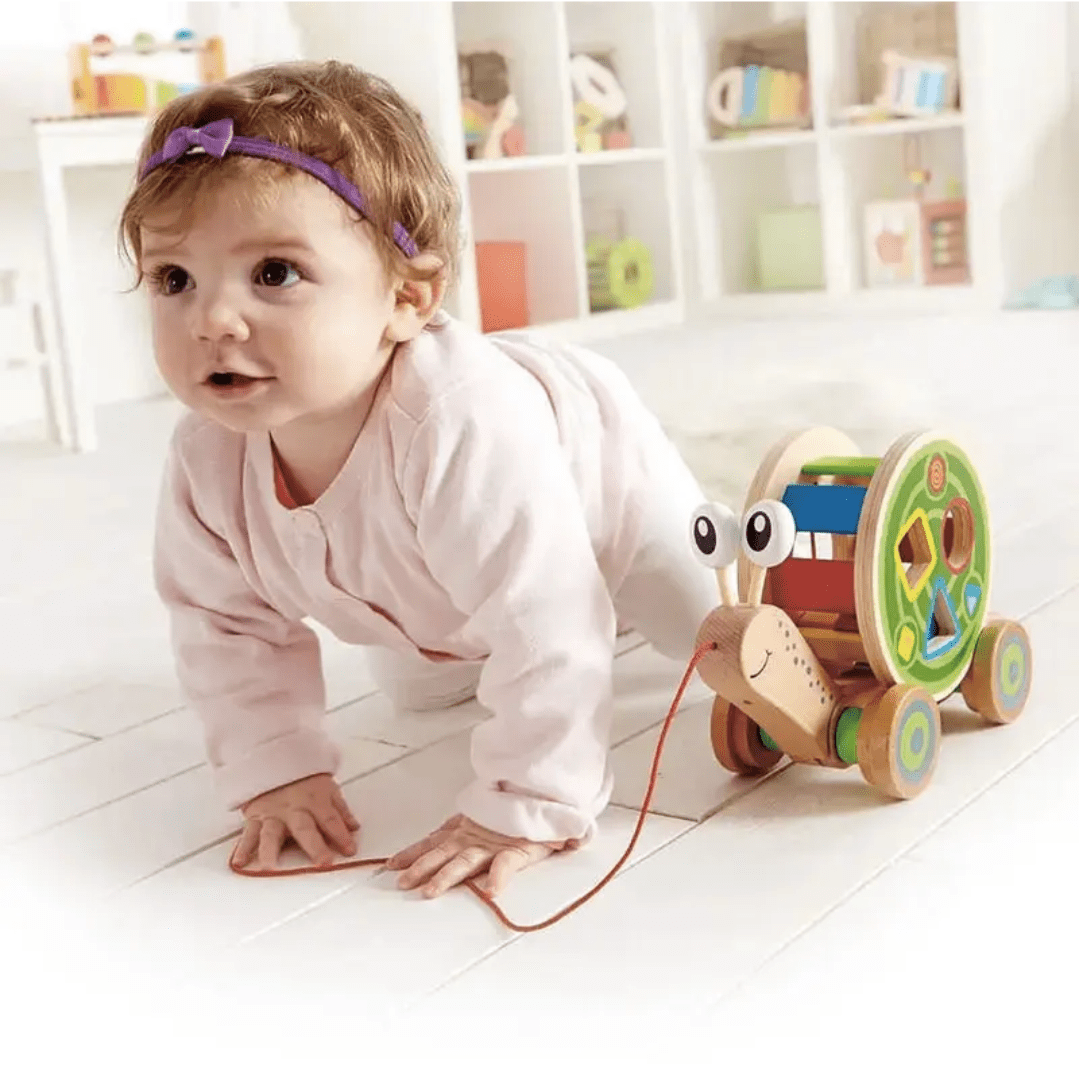 Crawling-Baby-Pulling-Along-Hape-Walk-A-Long-Snail-Naked-Baby-Eco-Boutique