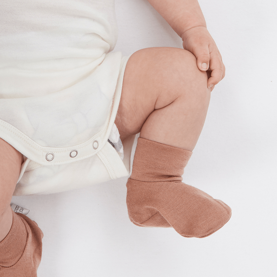 Cute-Baby-Legs-Wearing-Babu-Merino-Baby-Booties-Babu-Rose-Naked-Baby-Eco-Boutique