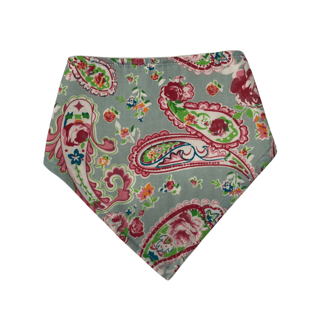 Meet the Elephant Ollie Bandana Bib by Elephant Ollie: a chic accessory showcasing a bandana design adorned with a paisley pattern in lively red, pink, and green floral accents set against a light gray backdrop—ideal for adding charm and style.