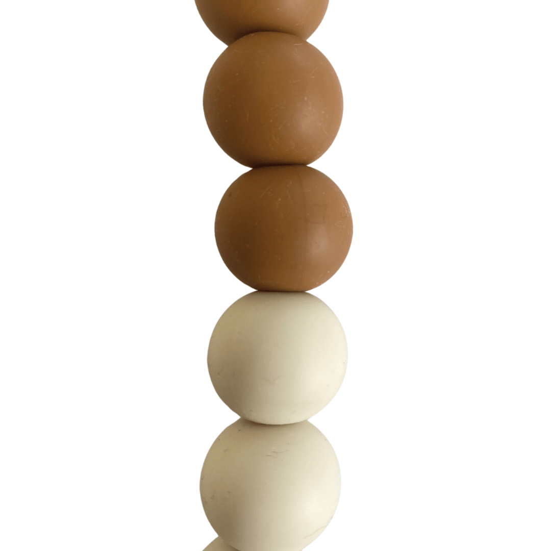 The Funny Bunny Kids Silicone & Beechwood Dummy Clip features a vertical stack of alternating brown and white spheres made from beechwood beads, offering a touch of natural elegance.