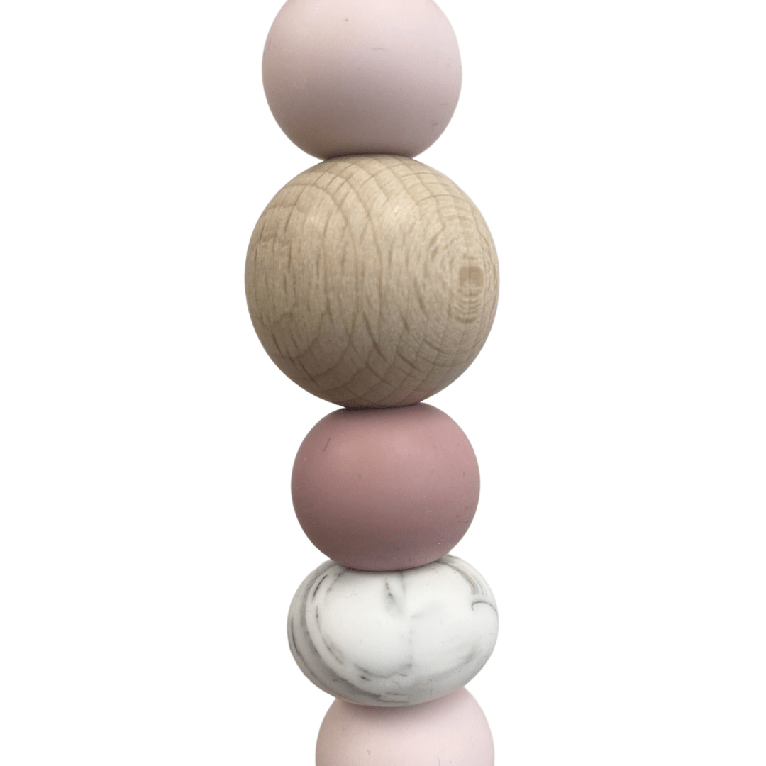 The Funny Bunny Kids Silicone & Beechwood Pram Garland features a delightful vertical arrangement of four beads on a rod: pink, wooden, pink, and marbled white—perfect for enhancing your baby's toy collection.