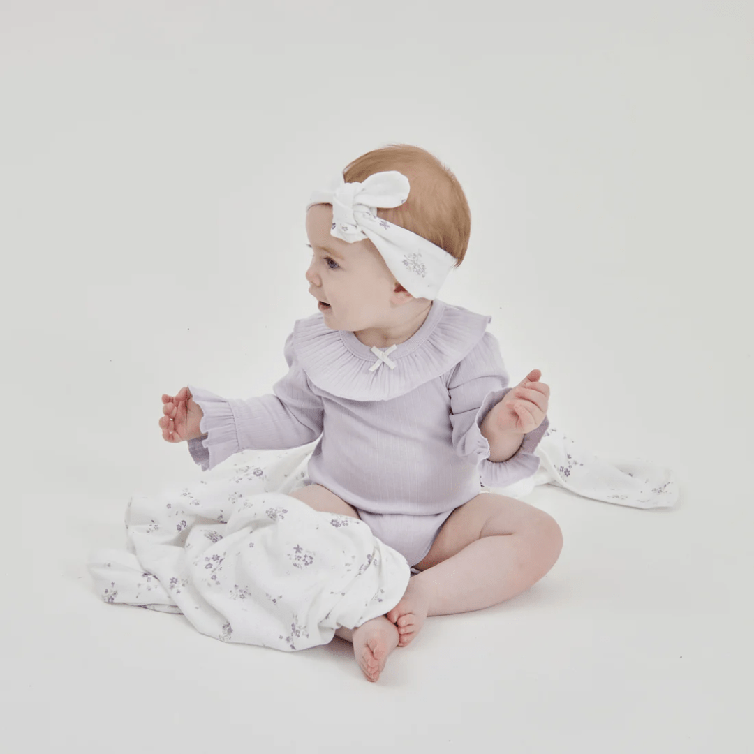 Happy-Baby-Sitting-Wearing-Aster-And-Organic-Lavender-Pointelle-Rib-Onesie-With-Matching-Headband-Naked-Baby-Eco-Boutique