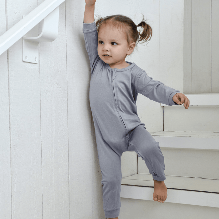 Happy-Girl-Wearing-Babu-Footless-Merino-Growsuit-Babu-Periwinkle-Naked-Baby-Eco-Boutique