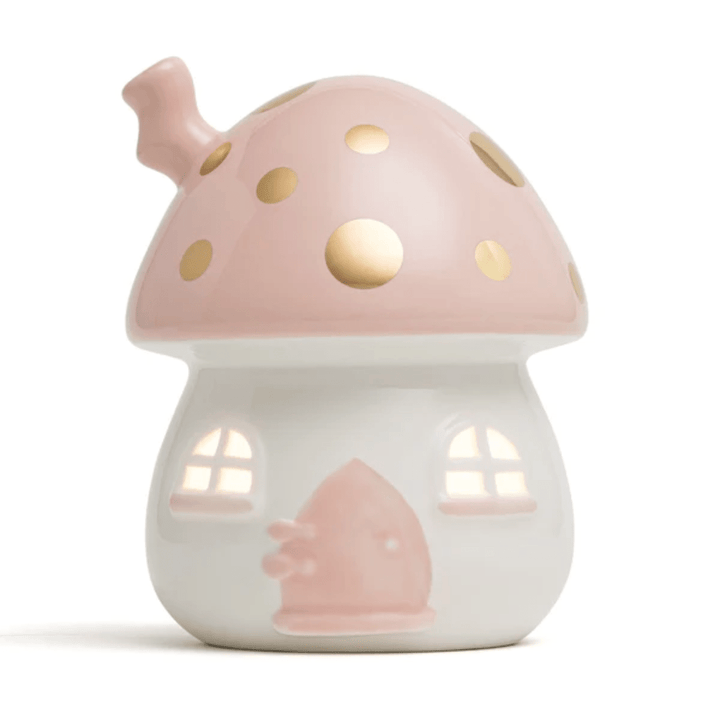 This enchanting Little Belle Nightlights Ceramic Nightlight, branded as LUCKY LASTS - FAIRY HOUSE ONLY, is a handcrafted porcelain masterpiece. It features a delightful ceramic lamp shaped like a mushroom with pink and gold accents. The base is adorned with delicate windows and a door, casting a gentle glow that creates an irresistible magical atmosphere.