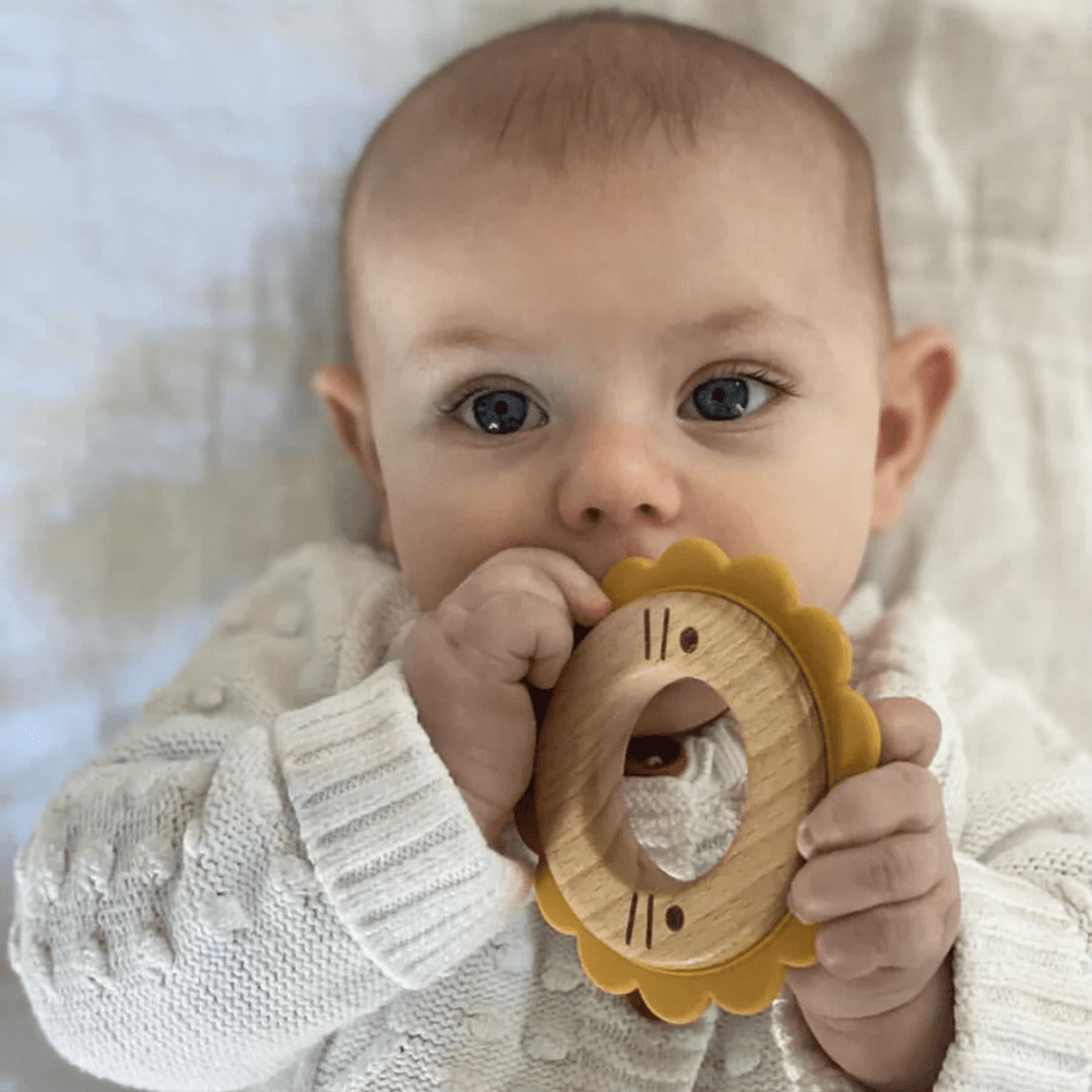 Little-Baby-Chewing-On-Over-The-Dandelions-Wood-And-Silicone-Teether-Leo-The-Lion-Naked-Baby-Eco-Boutique