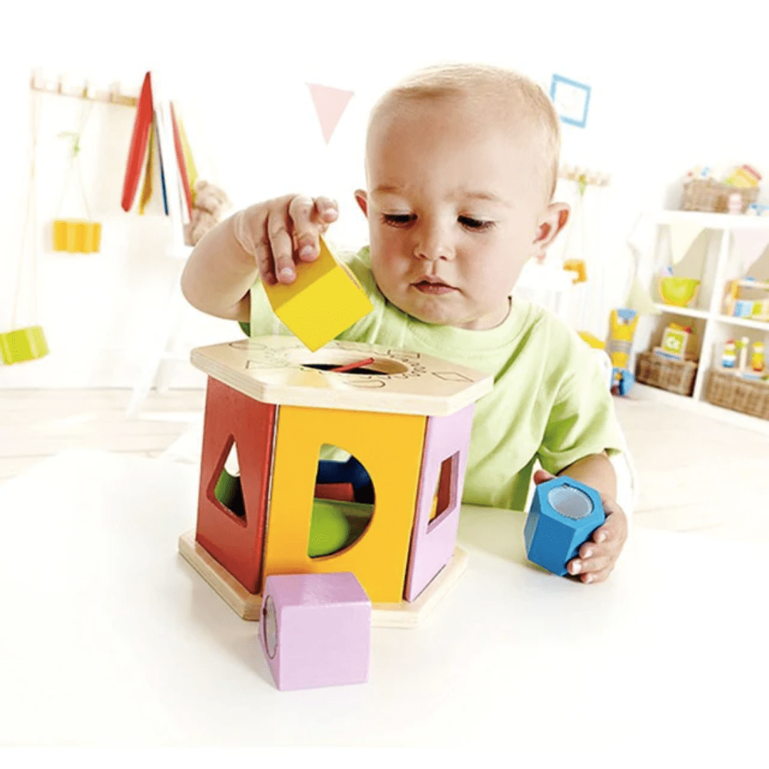 Little-Baby-Putting-Yellow-Shape-Into-Hape-Shake-And-Match-Shape-Sorter-Naked-Baby-Eco-Boutique