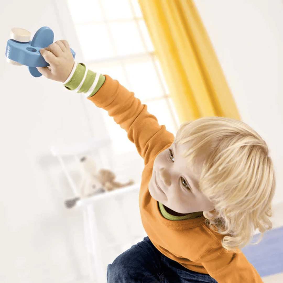 Little-Boy-Playing-With-Hape-Little-Plane-Naked-Baby-Eco-Boutique