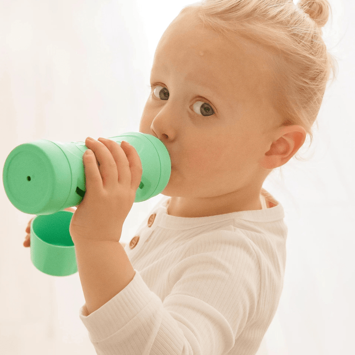 Little-Girl-Eating-From-Subo-Food-Bottle-Mint-Naked-Baby-Eco-Boutique