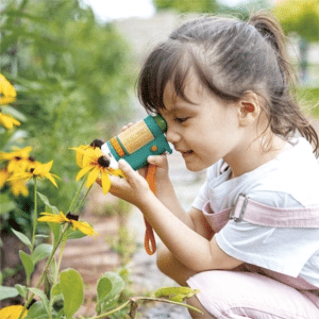 Little-Girl-Outdoors-Using-Hape-Portable-Microscope-Naked-Baby-Eco-Boutique