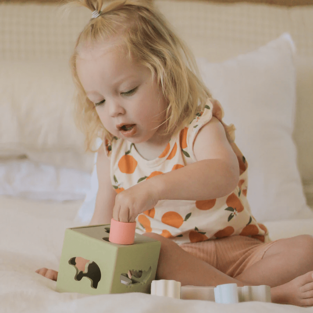 Little-Girl-Playing-With-Over-The-Dandelions-Silicone-Sorting-Box-Naked-Baby-Eco-Boutique
