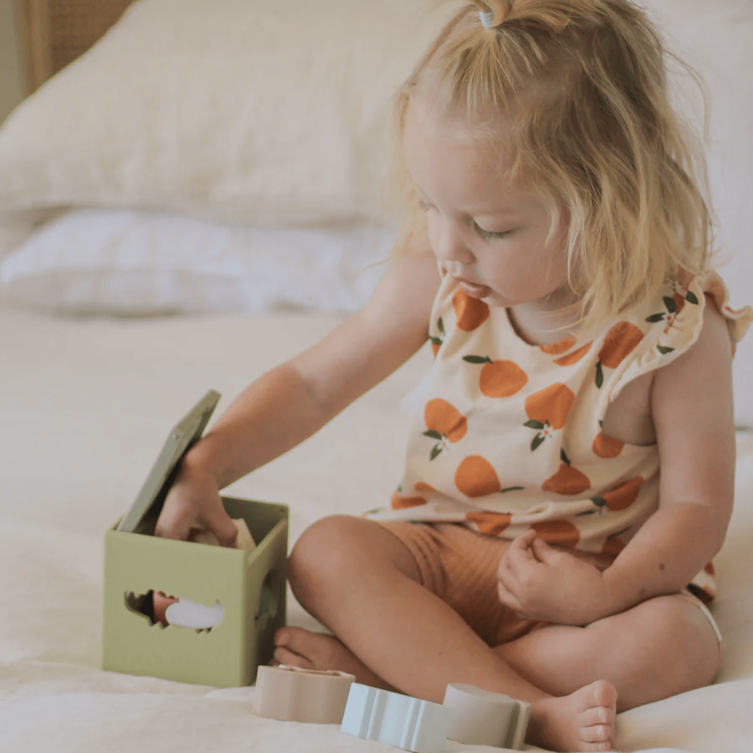 Little-Girl-Putting-Animal-In-Over-The-Dandelions-Silicone-Sorting-Box-Naked-Baby-Eco-Boutique