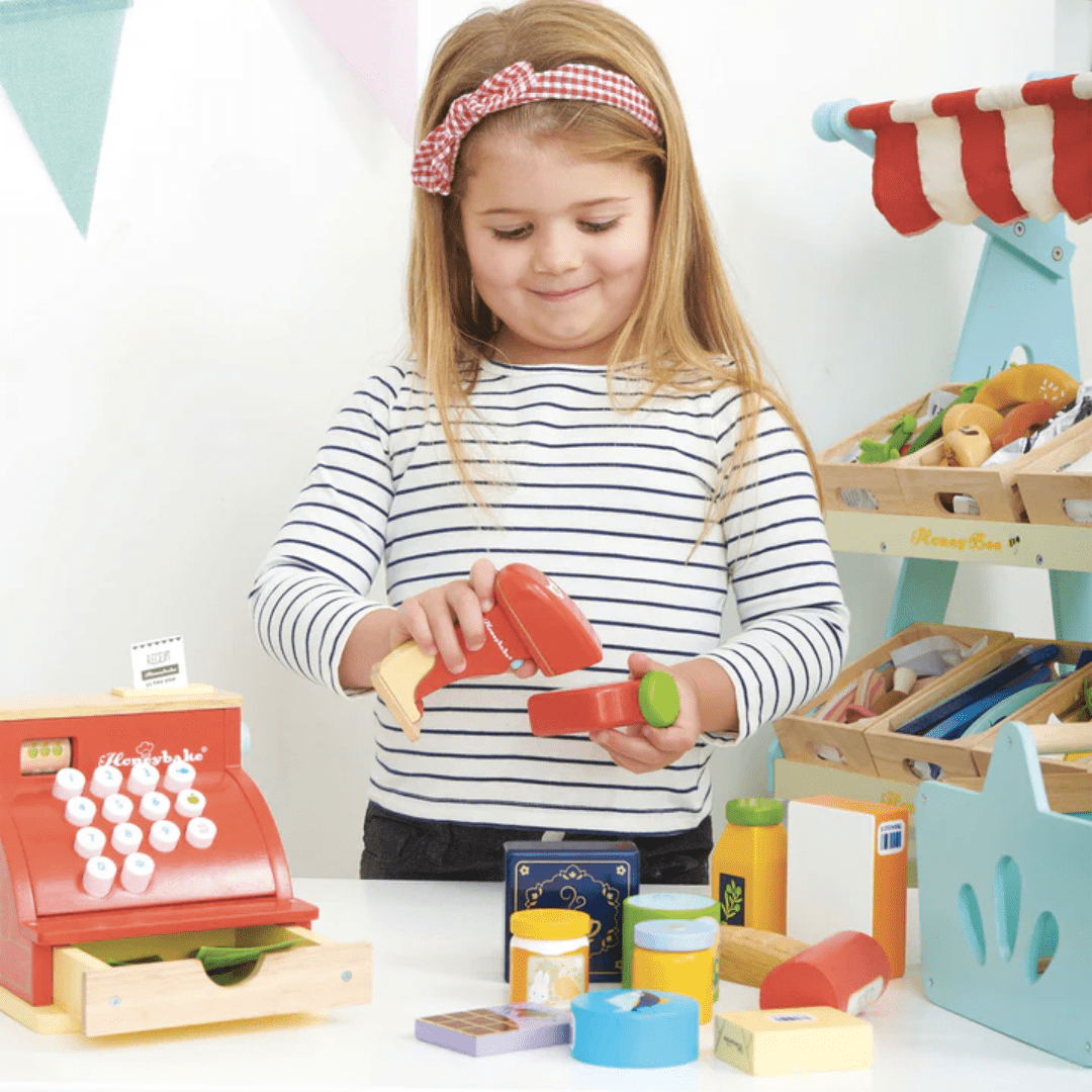 Little-Girl-Scanning-Groceries-With-Le-Toy-Van-Groceries-Set-And-Scanner-Naked-Baby-Eco-Boutique