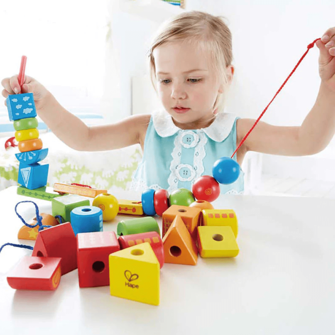 Little-Girl-Stringing-Hape-String-Along-Shapes-Naked-Baby-Eco-Boutique