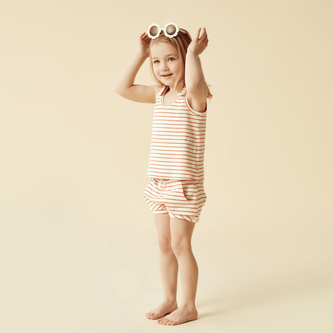 A little girl wearing Wilson & Frenchy Organic Rib Stripe Kids Bloomer Shorts.