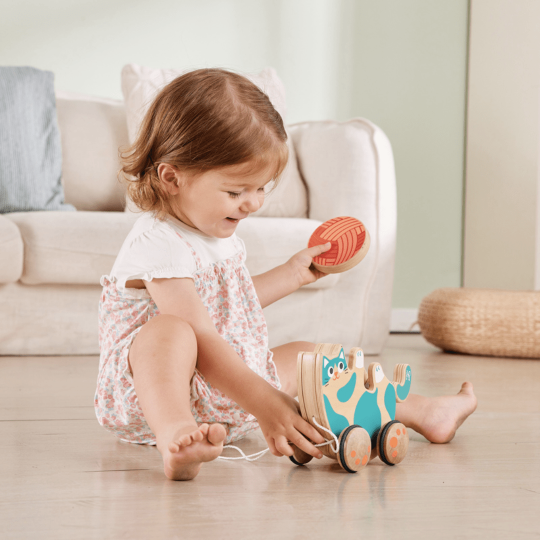 Little-Girl-With-Ball-Of-Wool-From-Playing-With-Hape-Roll-And-Rattle-Kitten-Naked-Baby-Eco-Boutique