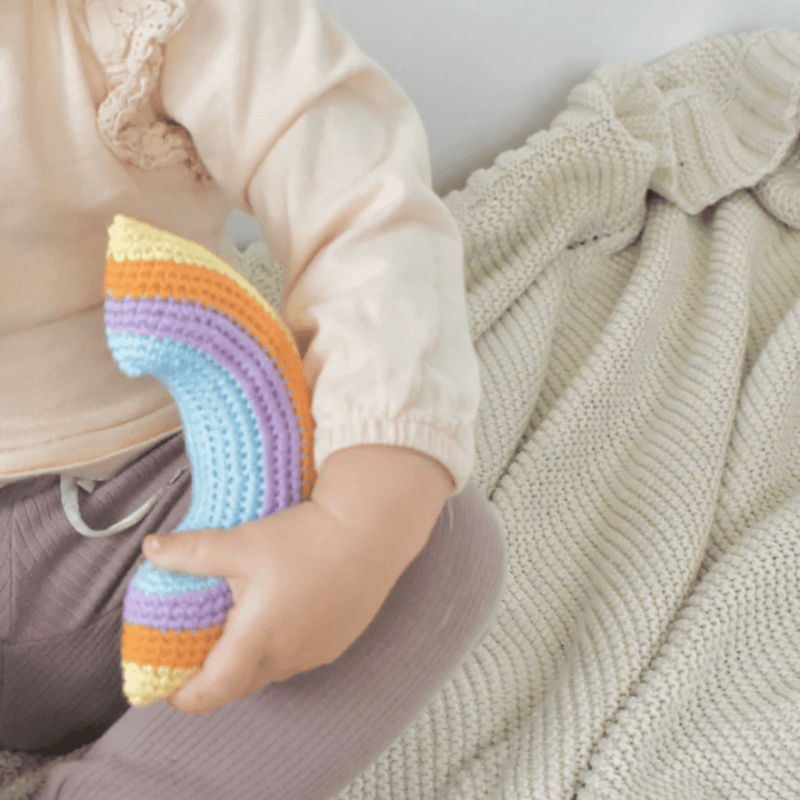 Little-Hand-Holding-Over-The-Dandelions-Rainbow-Rattle-Naked-Baby-Eco-Boutique