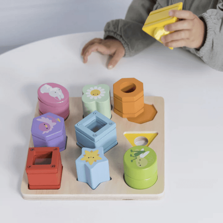 As a child engages with the Le Toy Van Petilou Sensory Shapes, they enhance their fine motor skills by exploring a range of geometric shapes. These vibrant shapes, featuring enchanting animal illustrations, are presented on a sturdy wooden toy board from Le Toy Van.