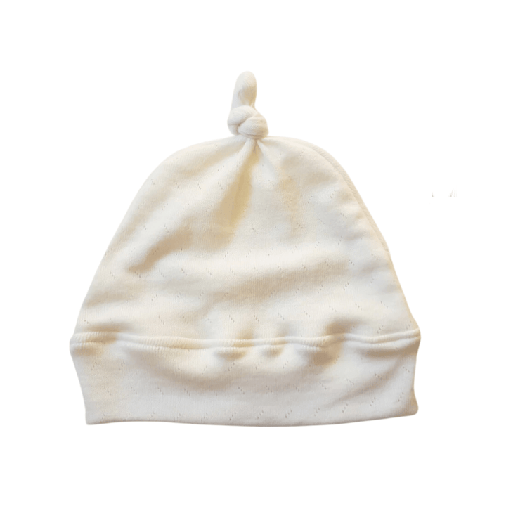 The Lola & Me Organic Top Knot Beanie, available in the limited "Lucky Lasts" collection for 0-3 months only, is crafted from organic materials and features a charming knot at the top. Displayed against a plain background, it is part of our exclusive handmade baby accessories by Lola & Me Organic Babywear.