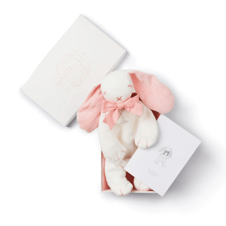 Maud N Lil's Organic Bunny Comforter - Gift Boxed is the perfect baby gift. This white plush bunny toy with pink ears and a pink bow comes in an open box, accompanied by a card featuring an illustration of the bunny. Crafted from organic cotton, this adorable toy is soft and safe for little ones.