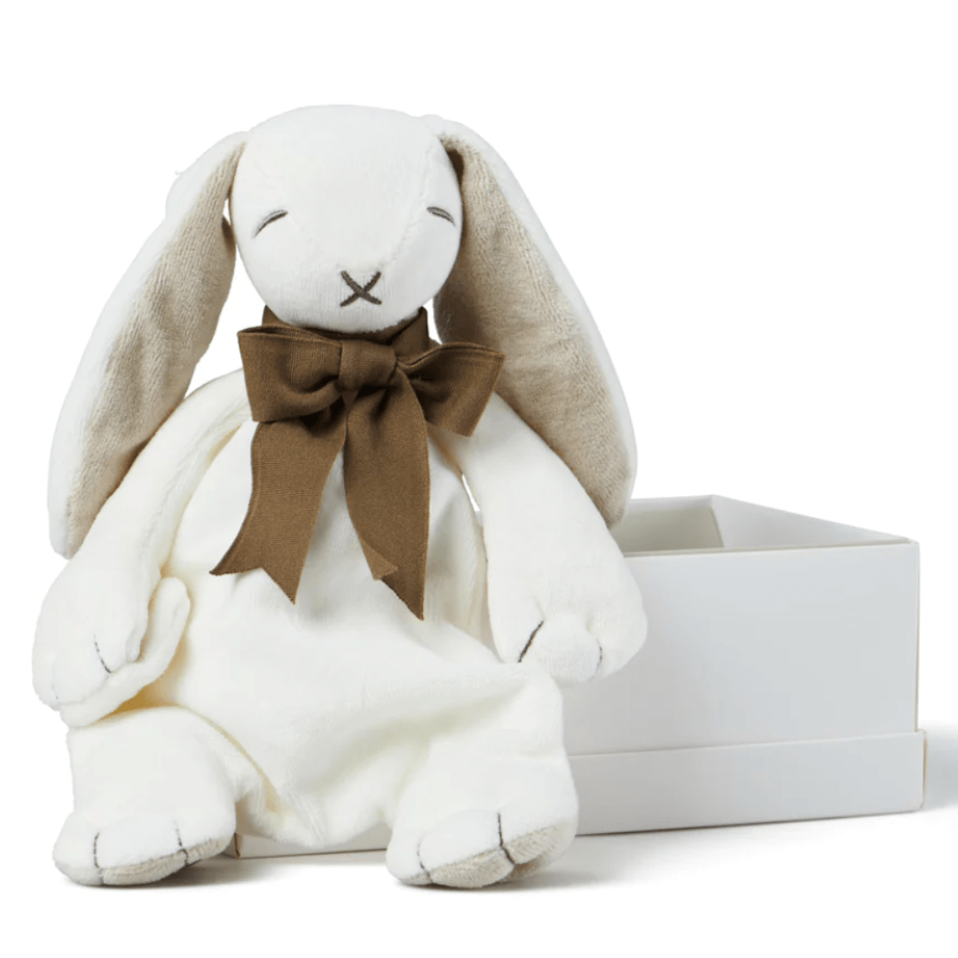 The Maud N Lil Organic Bunny Comforter - Gift Boxed, a plush white rabbit adorned with a brown bow and made from organic cotton, is seated beside an open white box.