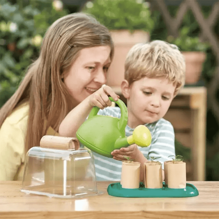 Mum-And-Child-Planting-Together-With-Hape-Growing-Gardeners-Greenhouse-Naked-Baby-Eco-Boutique