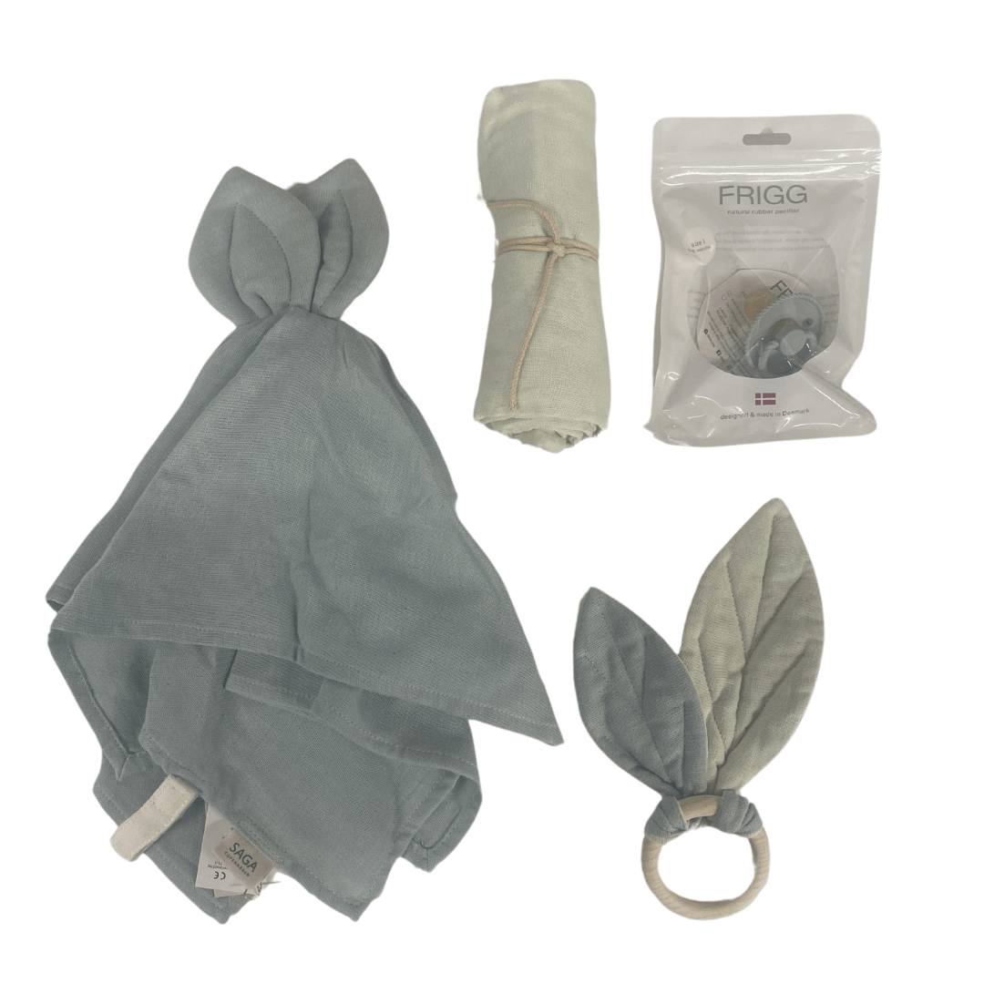 Introducing the Saga Copenhagen Gift Box - Elina by Saga Copenhagen, a delightful collection of baby accessories. This gift box includes a pacifier, a leaf design teether ring, and two soft green cloths, all crafted from organic cotton and beautifully packaged in eco-friendly materials.