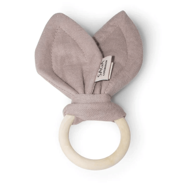 A pink Saga Copenhagen Organic Cotton + Beechwood Teething Ring.