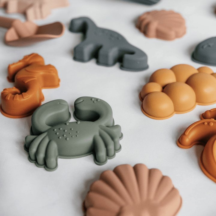 A group of Classical Child silicone beach toys arranged on a white surface.