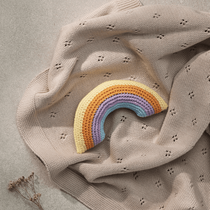Styled-Image-On-Blanket-Of-Over-The-Dandelions-Rainbow-Rattle-Naked-Baby-Eco-Boutique