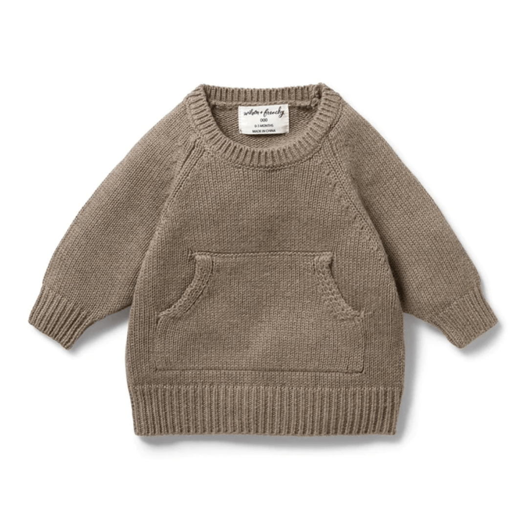 The Wilson & Frenchy Knitted Pocket Jumper - LUCKY LAST - 12-18 MONTHS ONLY is a charming heirloom piece, featuring a small, brown sweater design with a front pocket and long sleeves, elegantly set against a plain background.