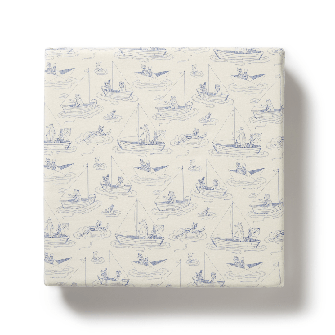 Wilson & Frenchy's Organic Cotton Cot Sheet in "Tribal Woods" design is perfect as a baby shower gift. This unique sheet features charming fishermen and sea creatures in light blue on a white background.