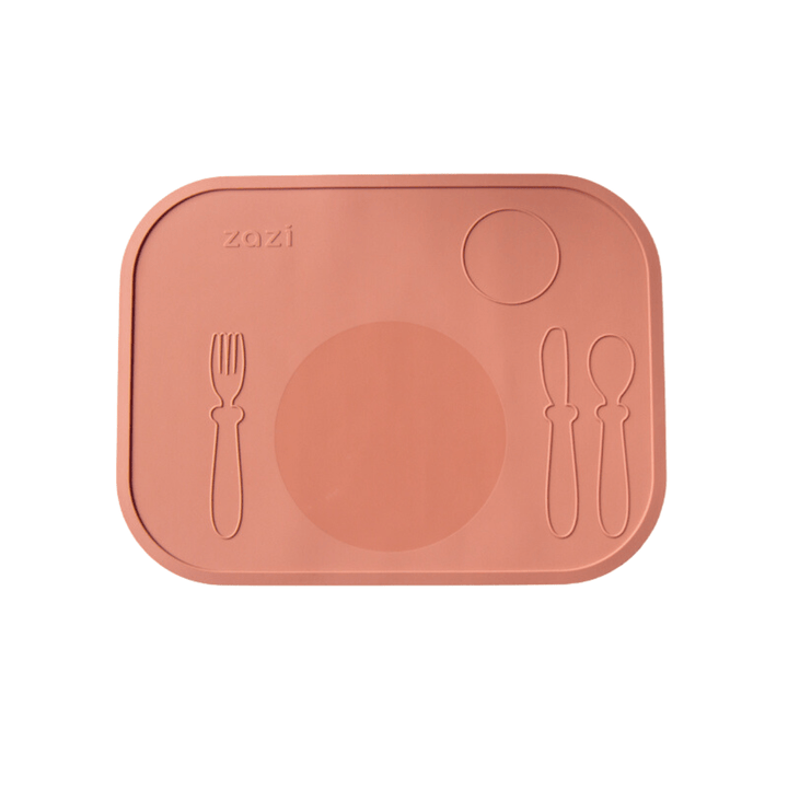 The Zazi Clever Mat by Zazi is a rectangular, pink-peach placemat made from food-grade silicone, with designated spots for a plate, fork, knife, and spoon. Its innovative suction technology ensures it stays securely in place during mealtime.