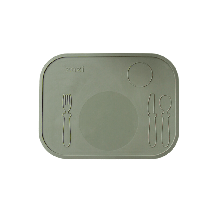 The Zazi Clever Mat, crafted from food-grade silicone, showcases a green placemat with molded sections for a fork, knife, spoon, plate, and cup. Additionally, its innovative suction technology ensures everything stays securely in place.