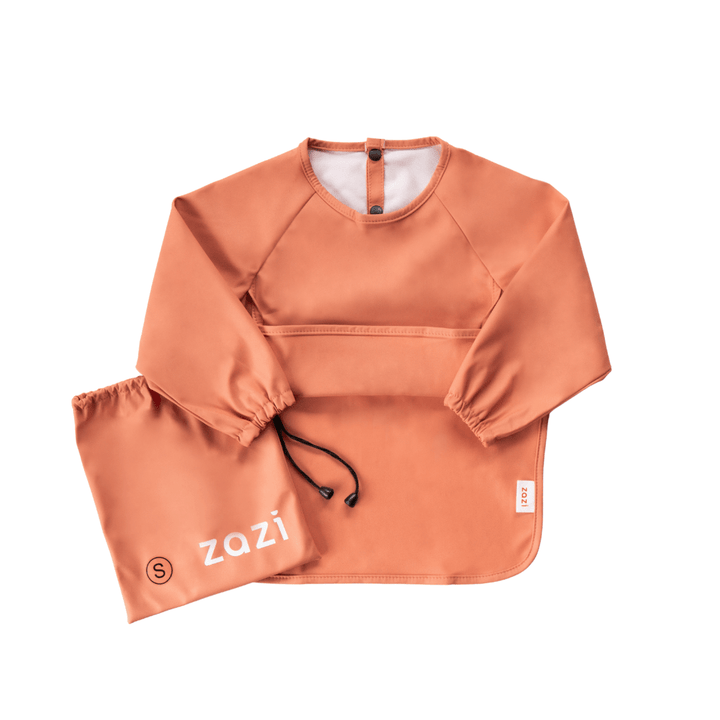 A Zazi Recycled Full-Sleeved Bib in small, featuring long sleeves, an orange color, a front pocket, and a matching drawstring bag labeled "Zazi." This machine washable bib is designed to keep your little one clean and stylish.