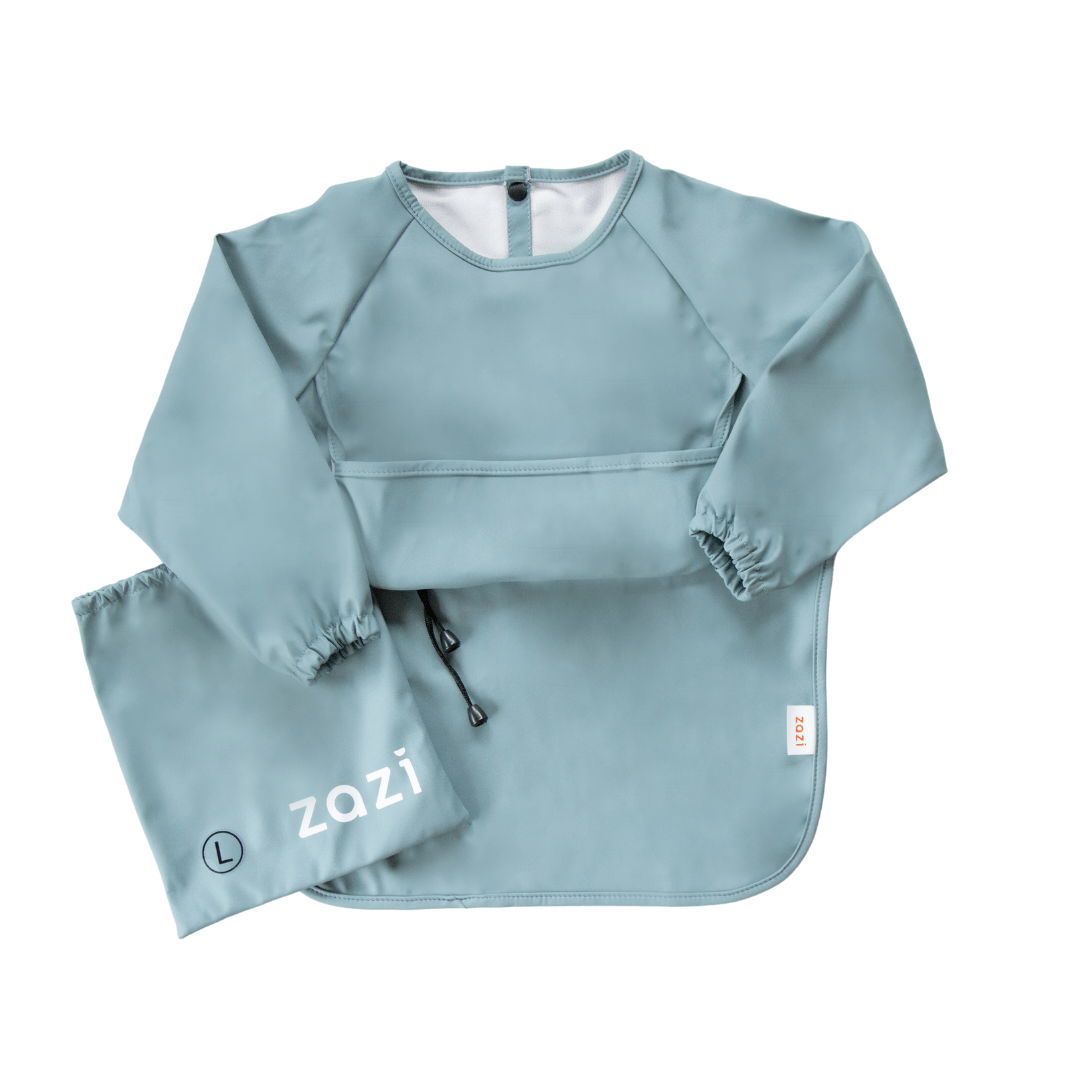 The Zazi Recycled Full-Sleeved Bib is a teal toddler smock with attached sleeves, a front pocket, adjustable back snaps, and a matching carry pouch labeled "Zazi." This waterproof, stain-resistant bib is perfect for little ones and is machine washable.