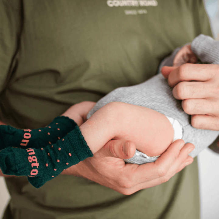 Adult-Holding-Baby-Wearing-Lamington-Merino-Wool-Crew-Baby-Socks-Brighton-Naked-Baby-Eco-Boutique