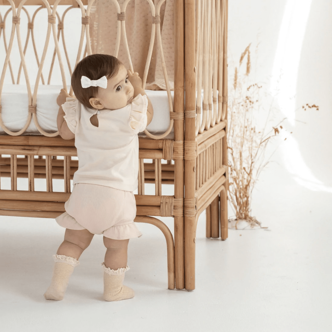 Aster-And-Oak-Organic-Rib-Ruffle-Bloomers-Peach-Rib-On-Little-Girl-Naked-Baby-Eco-Boutique