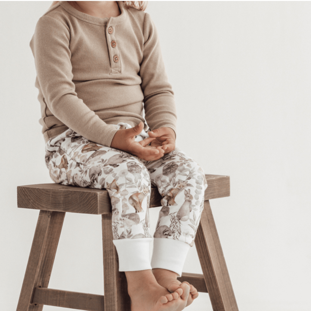 Aster-and-Oak-Organic-Cotton-Harem-Pants-Child-On-Stool-Wearing-Woodland-Pants-Naked-Baby-Eco-Boutique