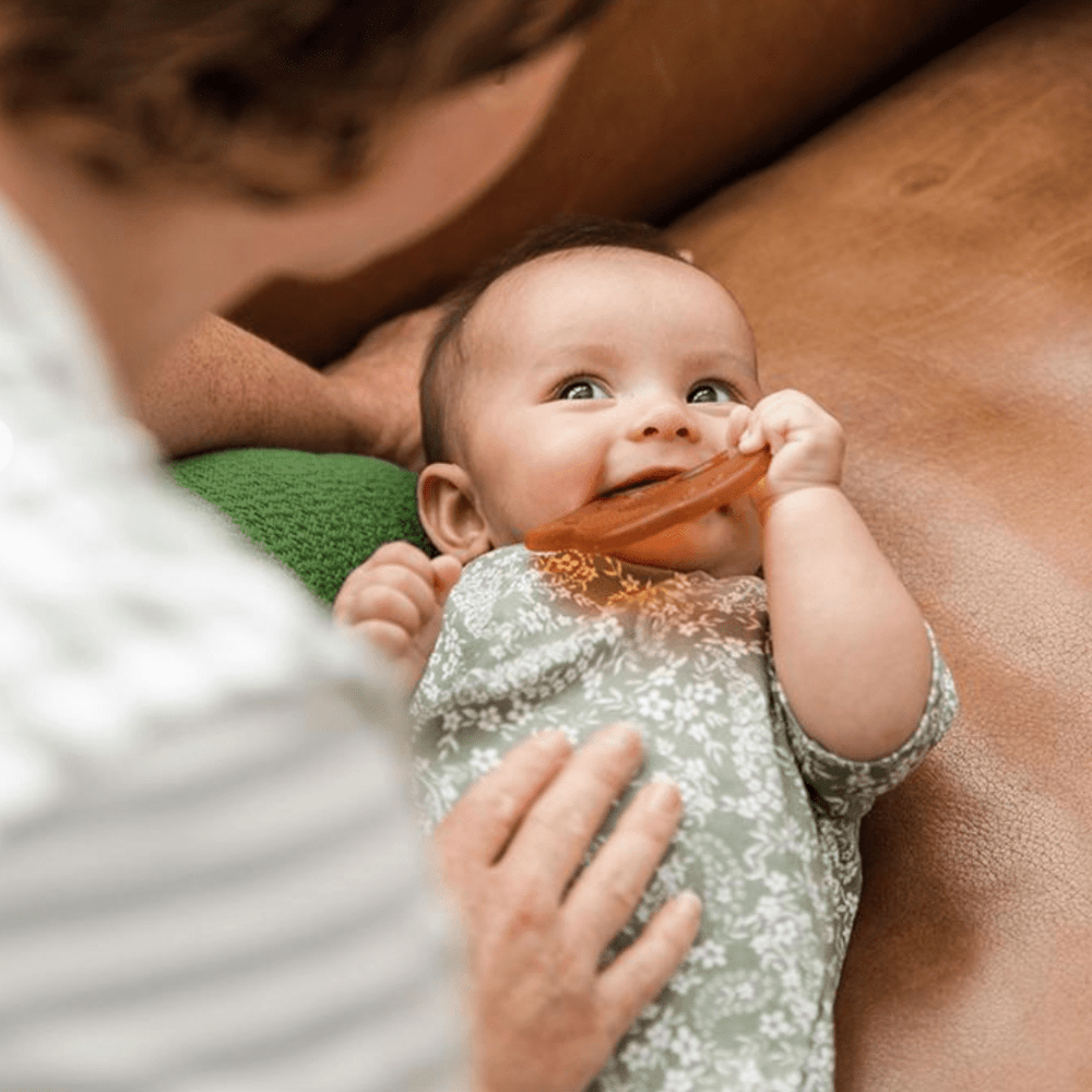 Baby-Chewing-on-Haakaa-Silicone-Owl-Teether-Naked-Baby-Eco-Boutique